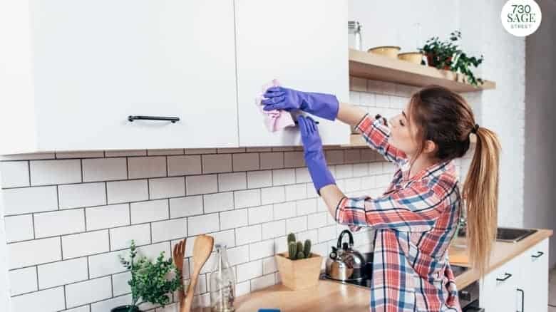Woman cleaning her kitchen cabinets