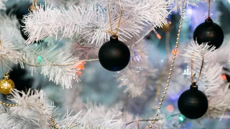 Black ornaments on white tree