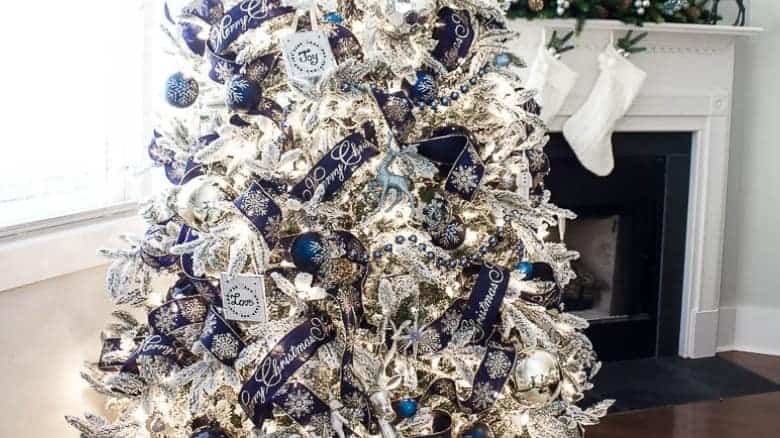 Blue ornaments and white christmas tree