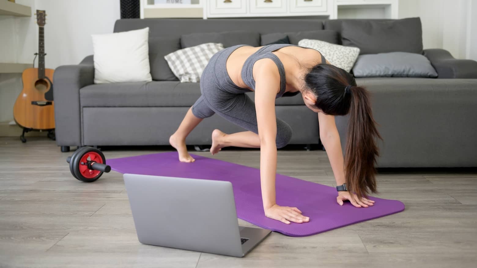 Spell Your Name Workout For Adults 1 Young woman in fitness outfit doing a set of mountain climbers on her yoga matt
