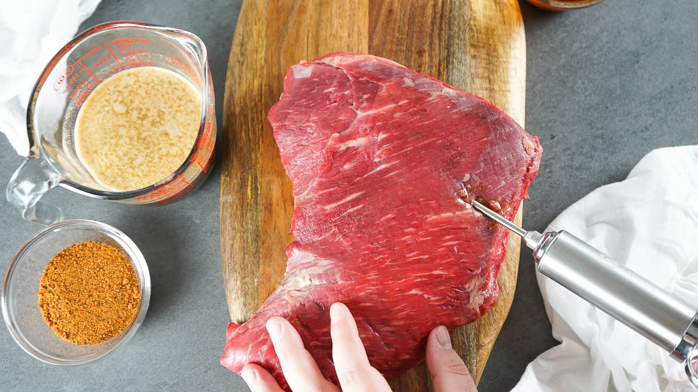 Injecting smoked Tri-tip in grid pattern with meat injector and homemade marinade.