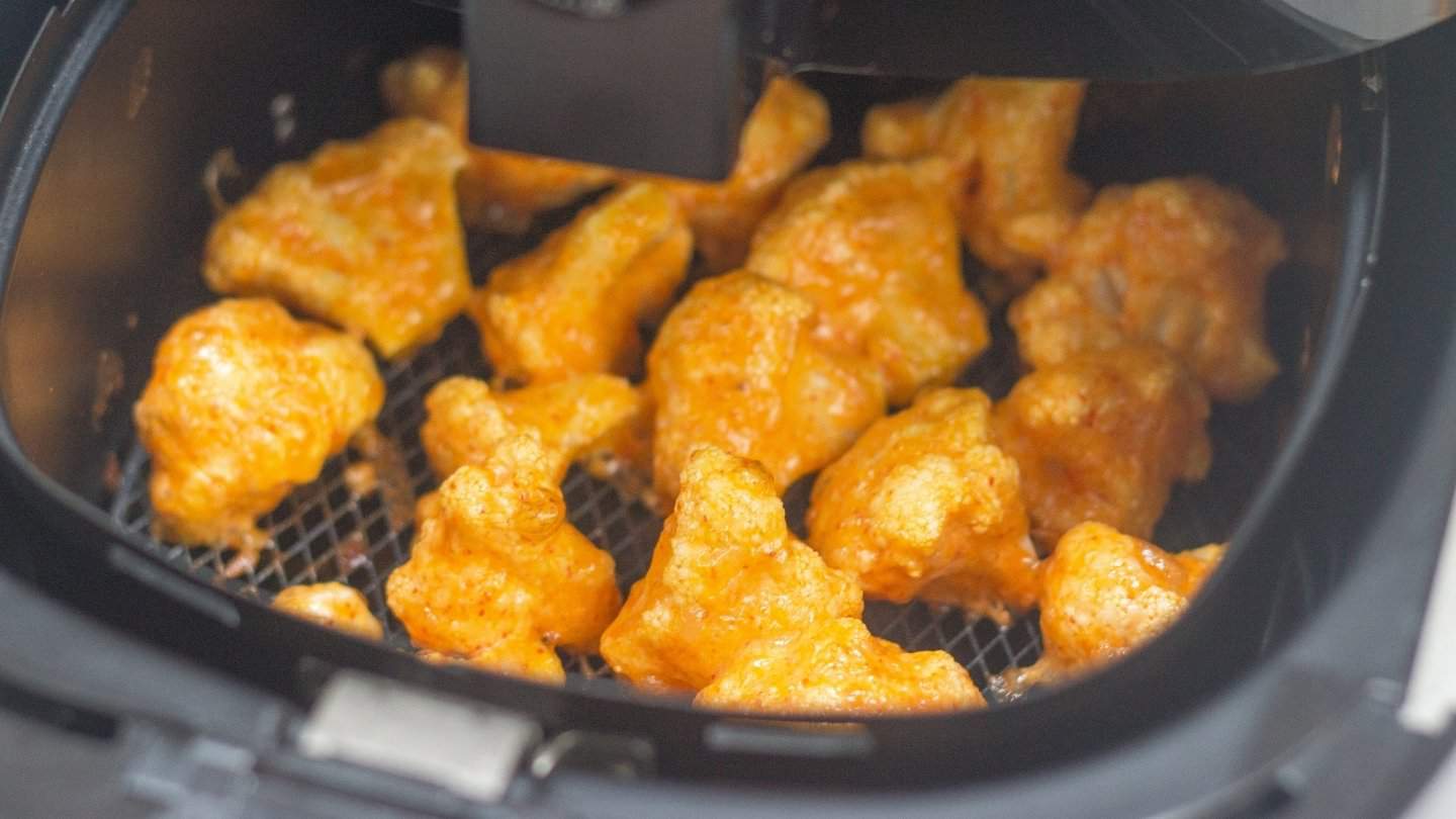 cooked cauliflower florets  in a airfryer basket