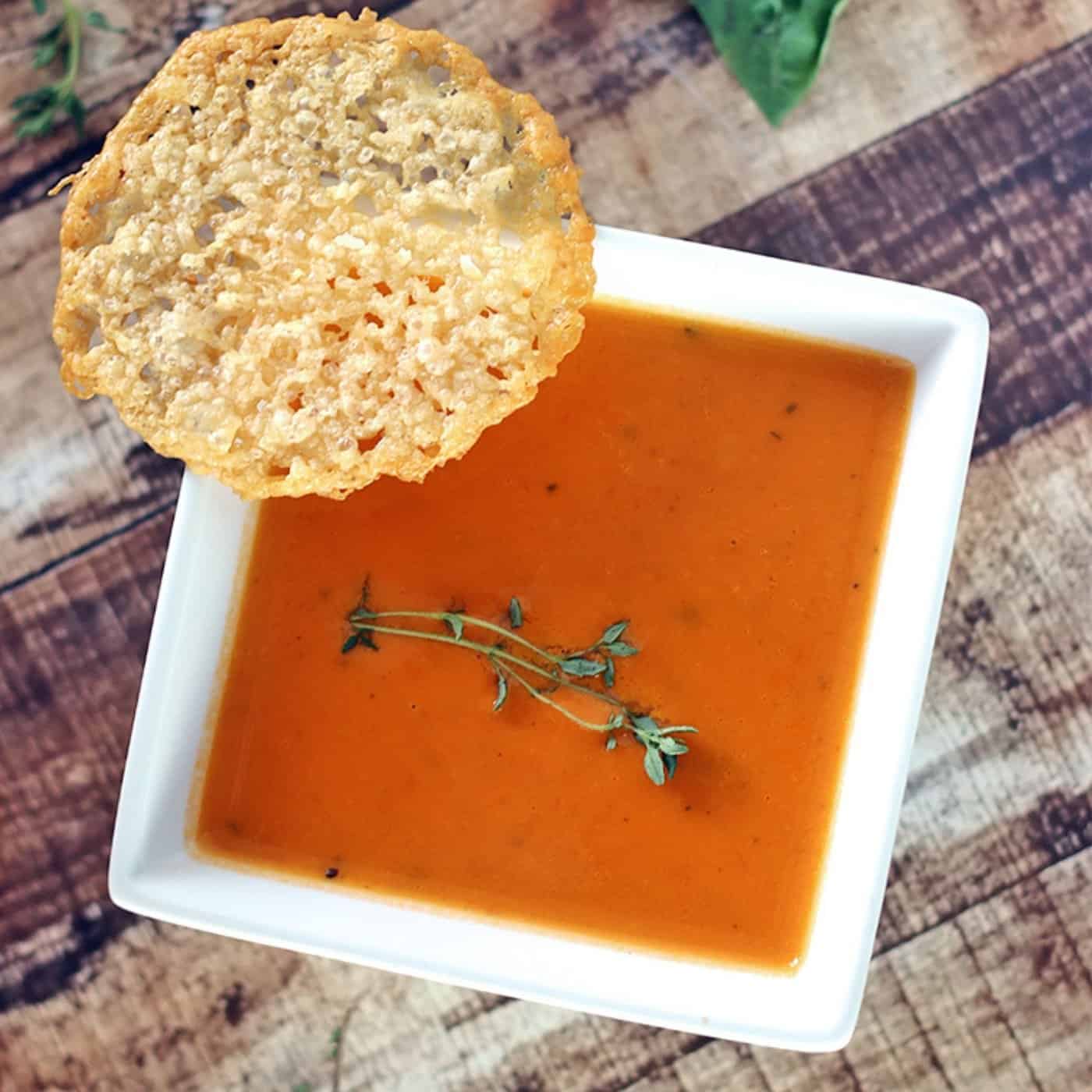 bowl of keto tomato soup  with cheese crisps