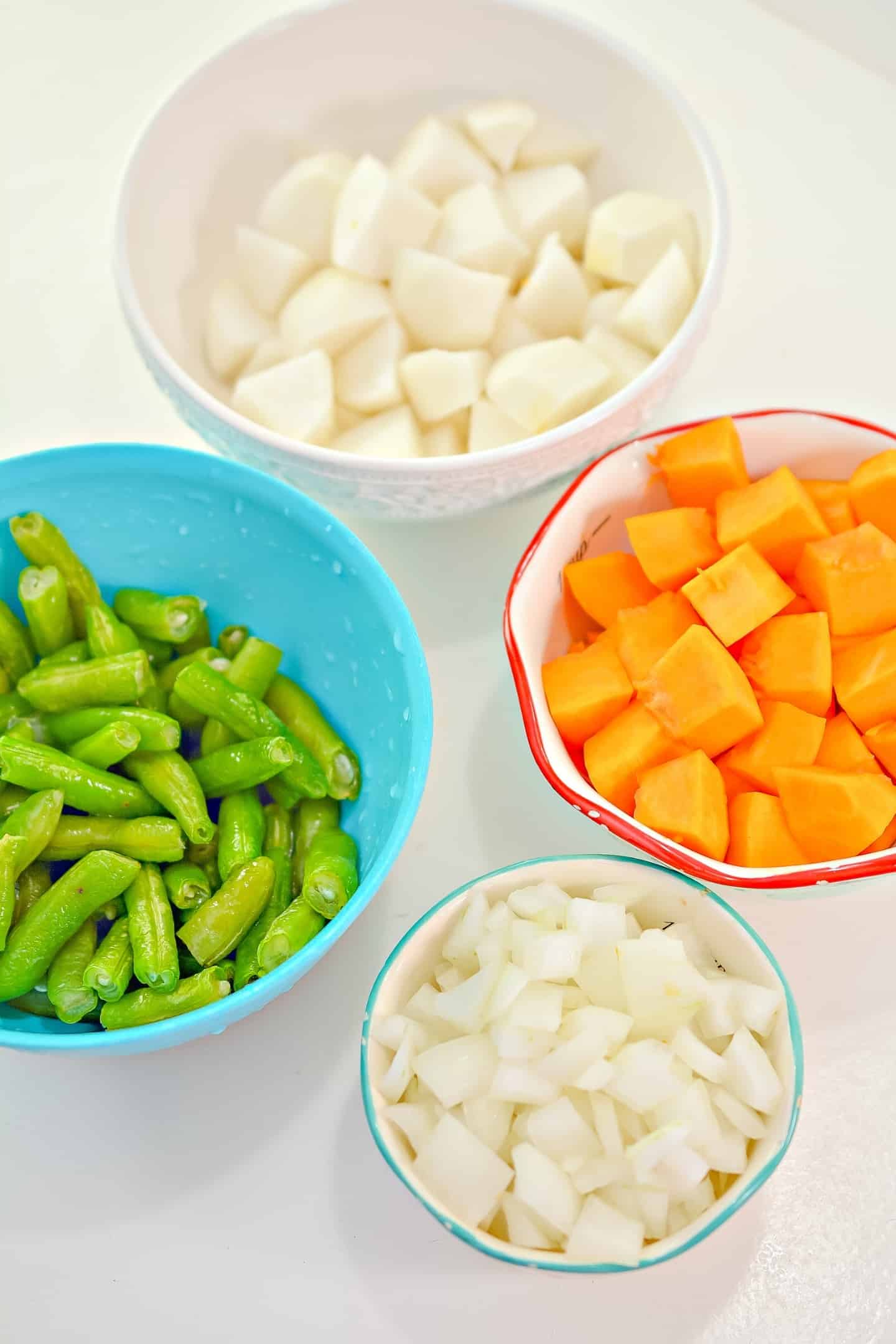 green beans, pumpkin squash in cubes, diced onion and turnips in bowls