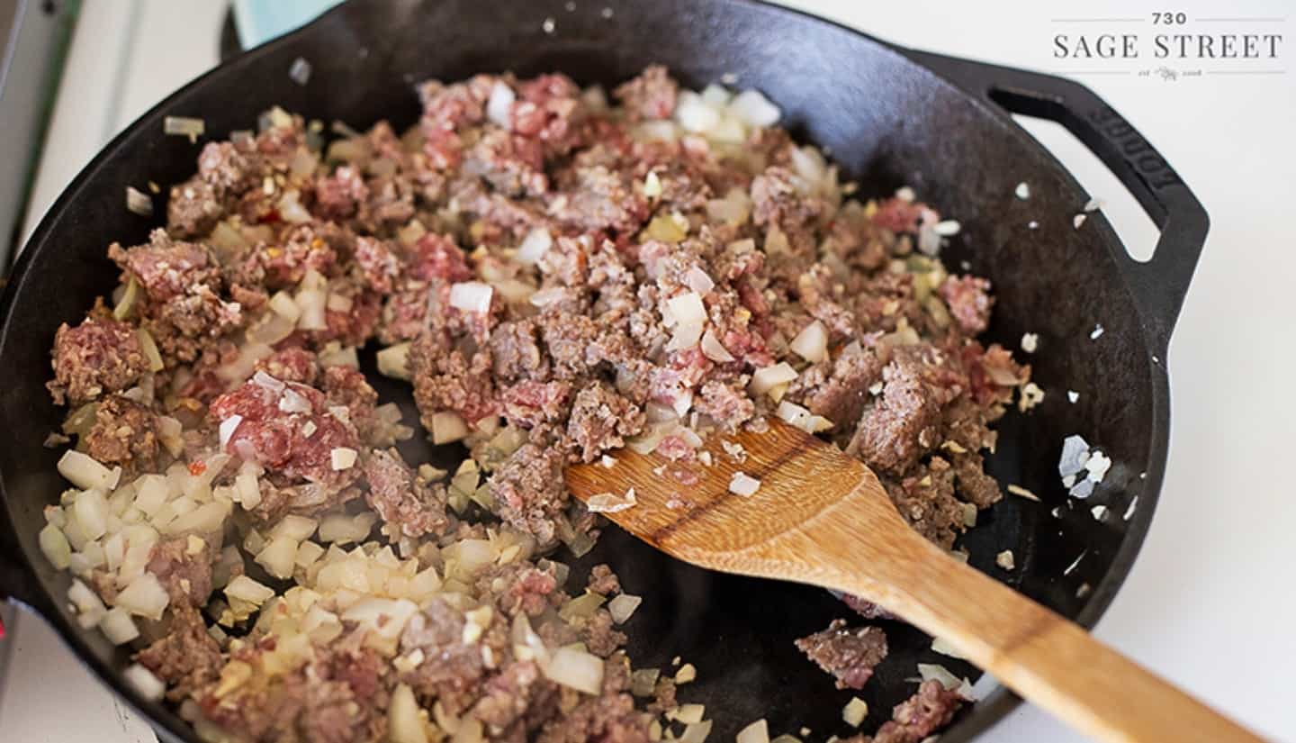 onion meat and garlic on a skillet browned