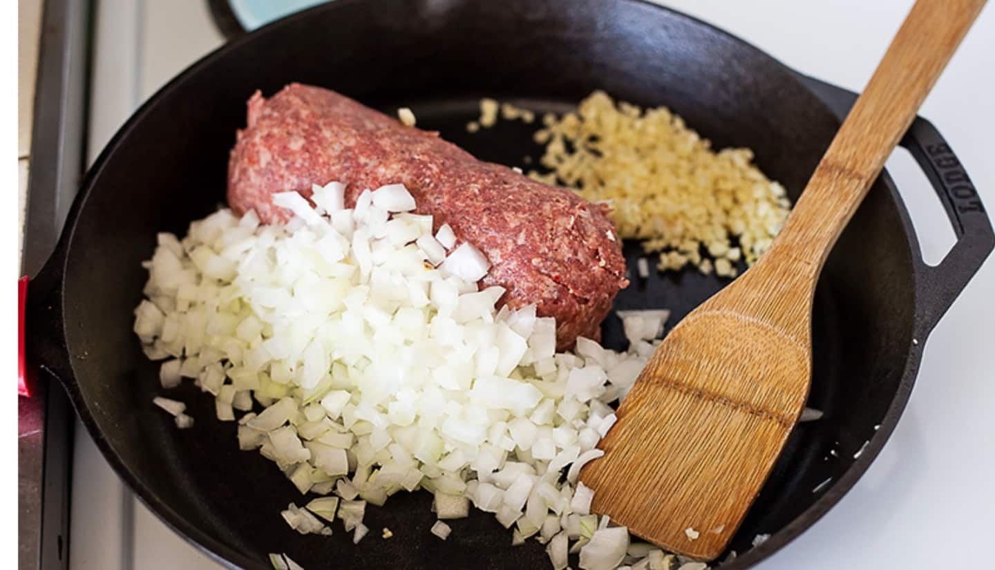 onion meat and garlic on a skillet