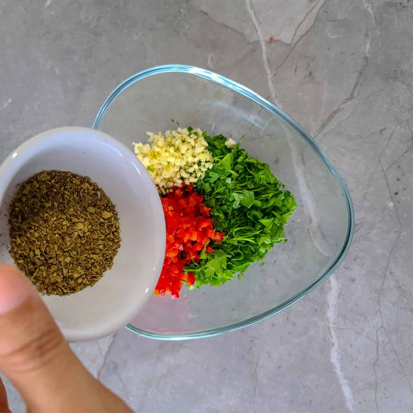 Add the dried oregano to the bowl.