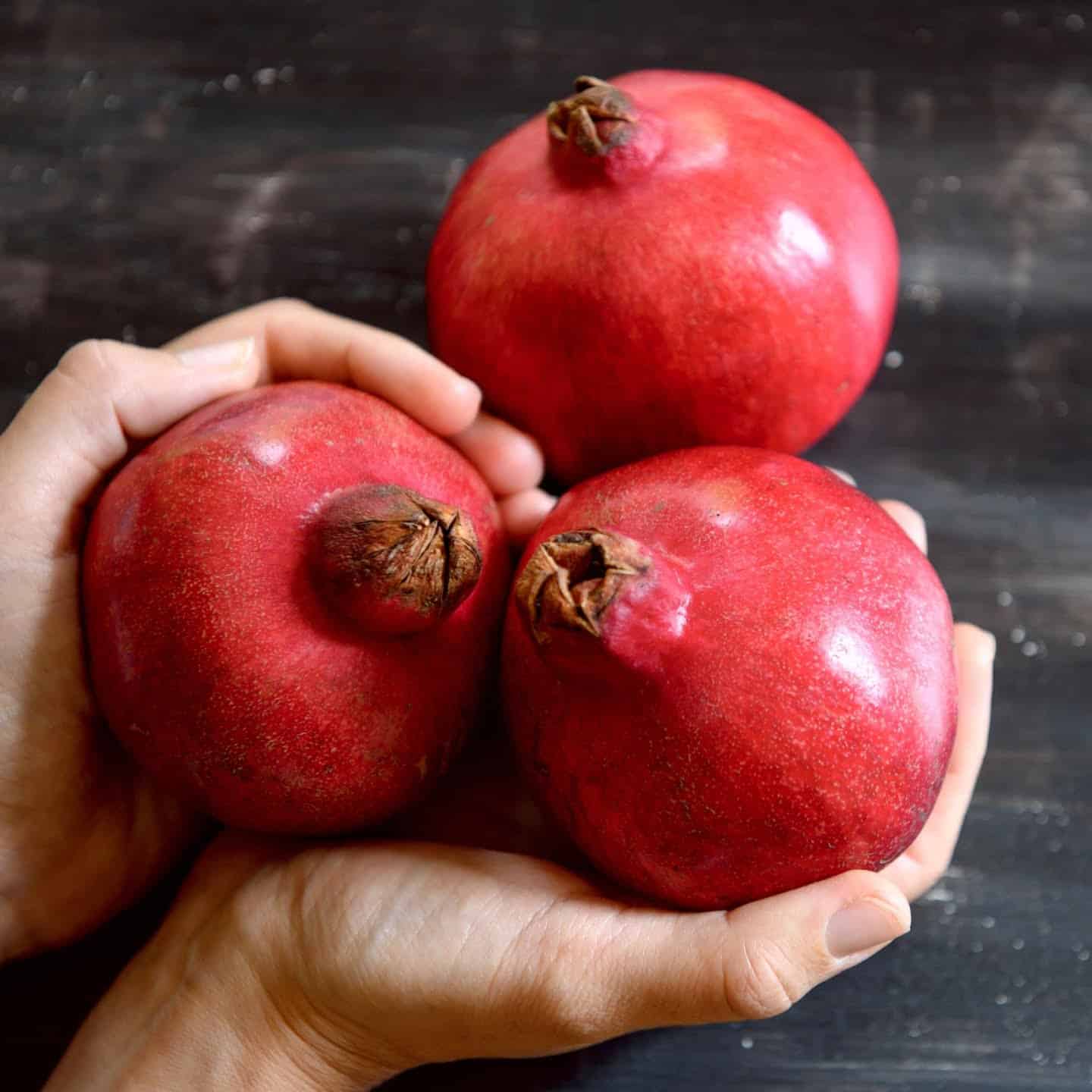 Three perfect pomegranates ready to cut and eat
