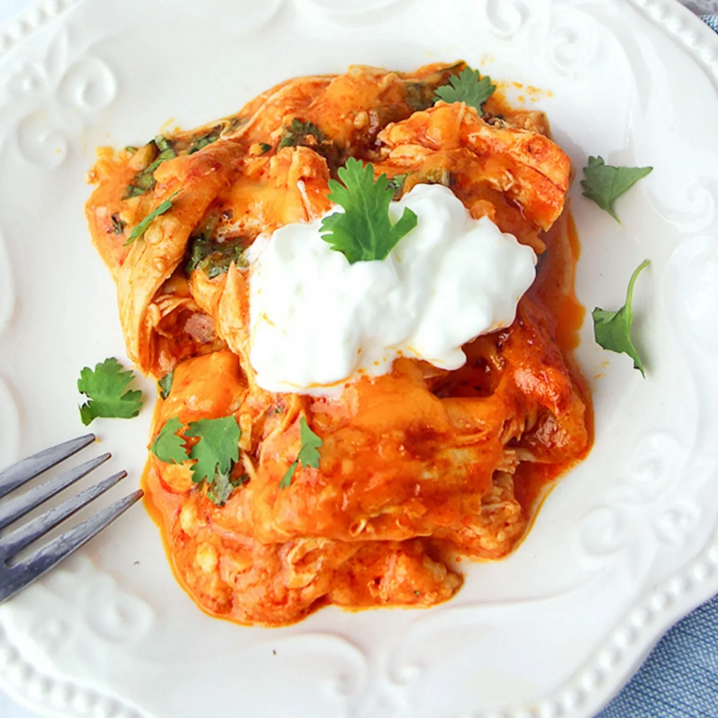 Chicken enchilada casserole  with sour cream on top 