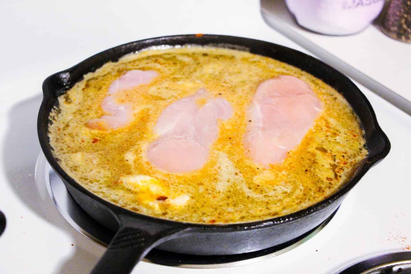 chicken breast cooking in skillet