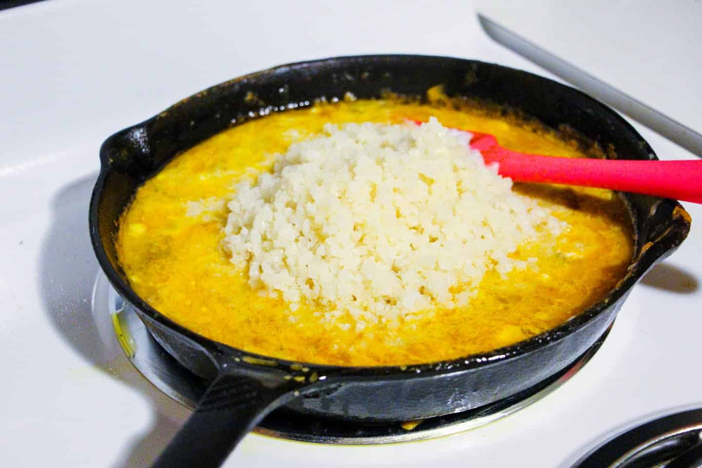 cauliflower rice cooking in skillet