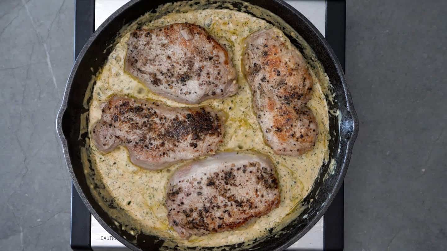 pork chops into the cream sauce in the cast iron skillet