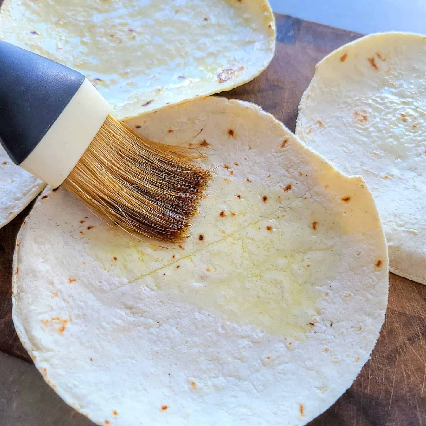 brushing tortillas