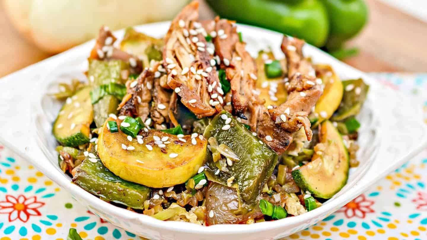 chicken stir fry with sliced green onions, chopped cilantro, and red pepper flakes