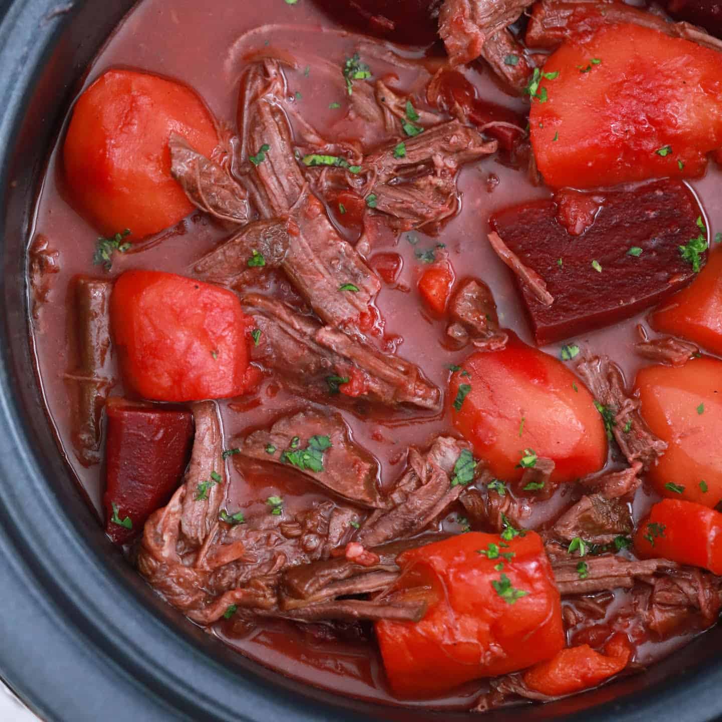 Crock pot roast beef cooking slowly.