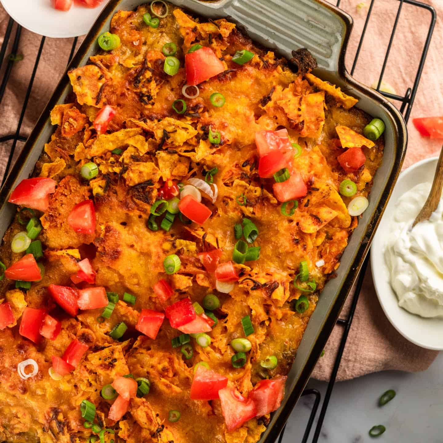 doritos casserole with sour cream and green onions with tomatoes
