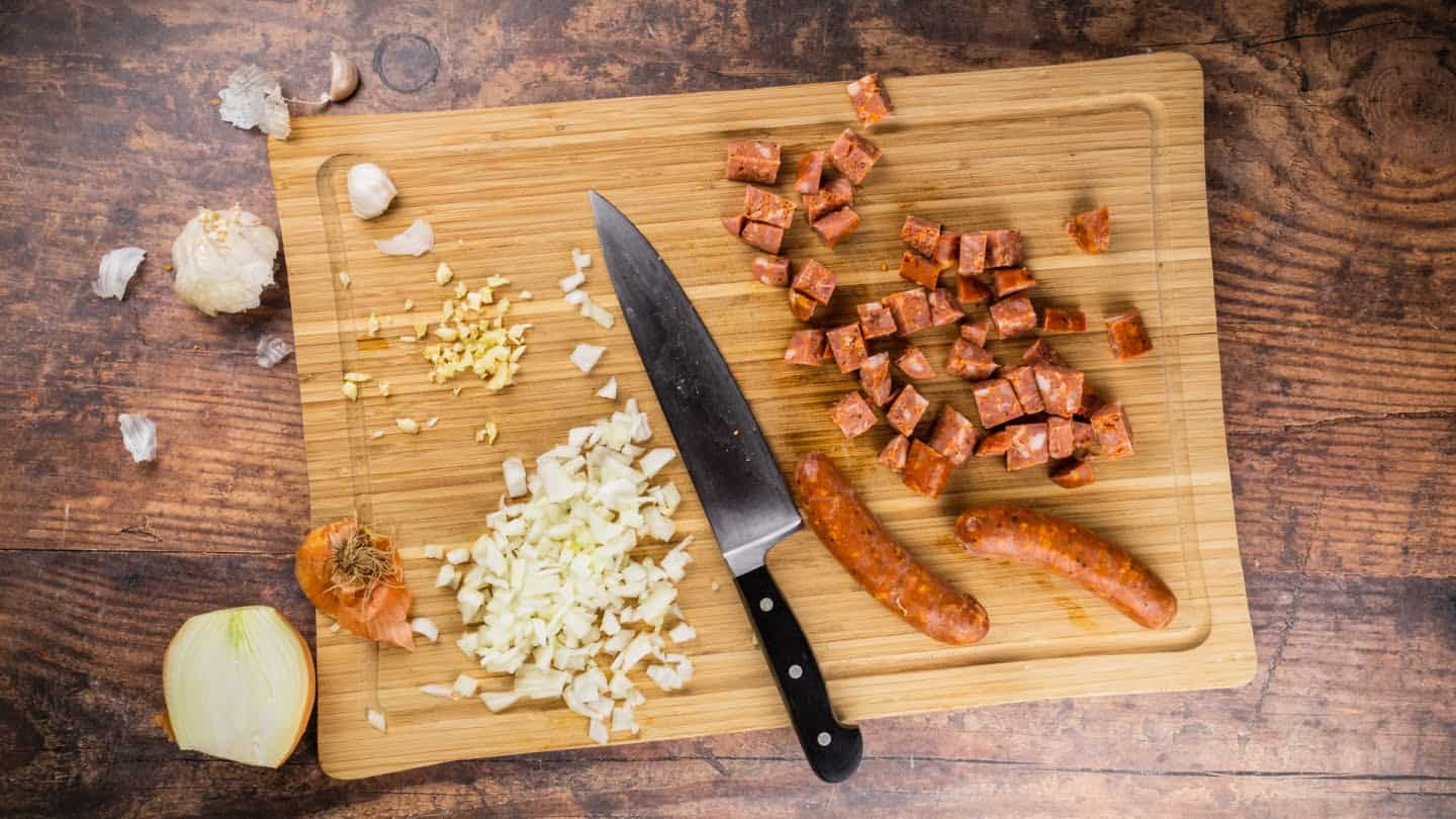 andouille sausage into pieces and then finely dice the onion and garlic