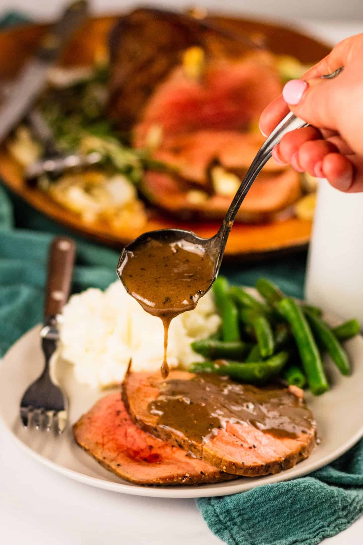 roast beef with mashed potatoes and green beans with brown gravy