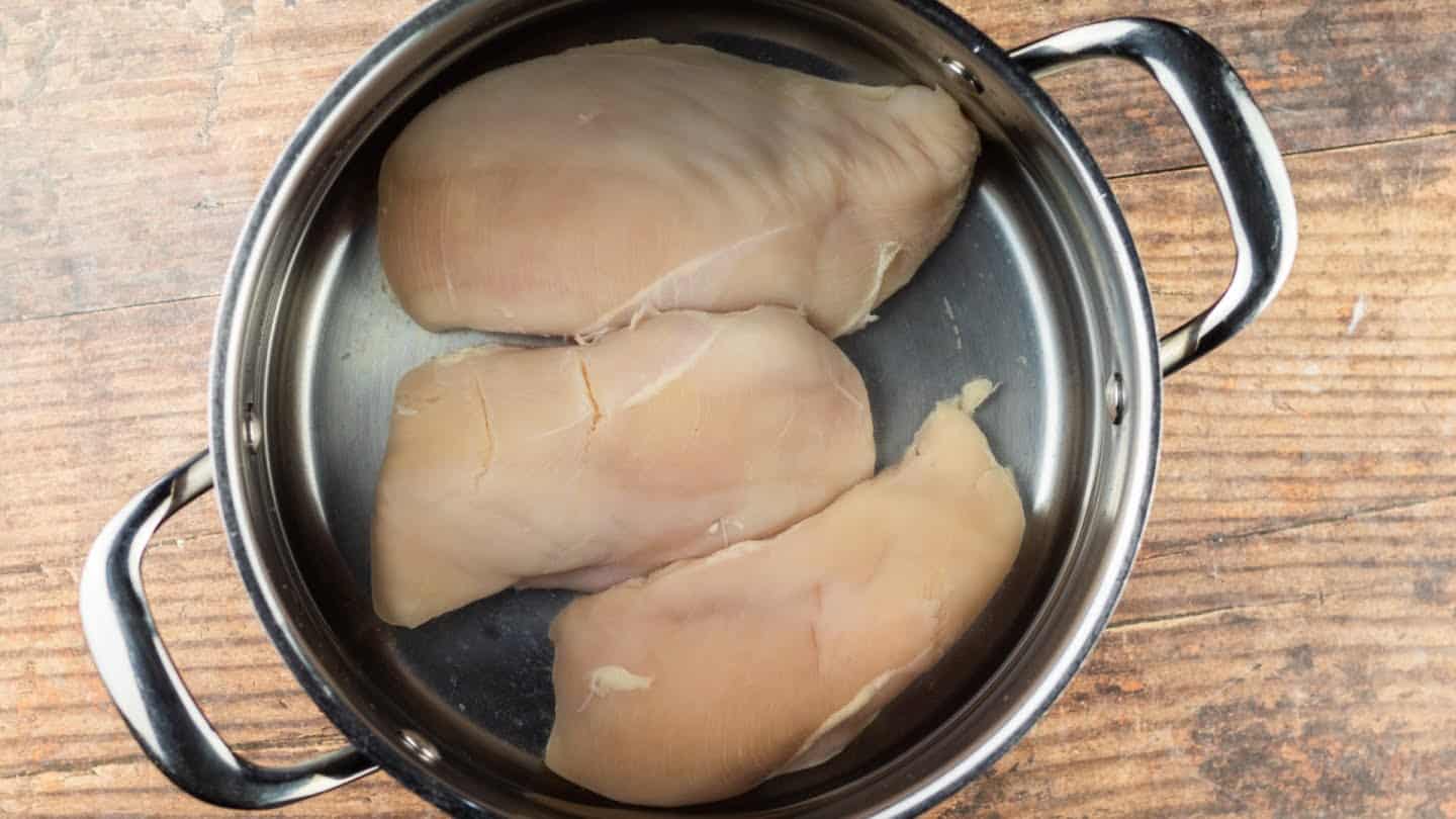 boiling chicken breasts in a pan