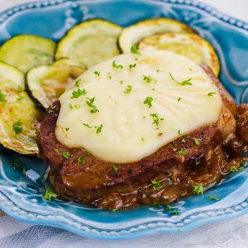 onion gravy smothered steak with zucchinis