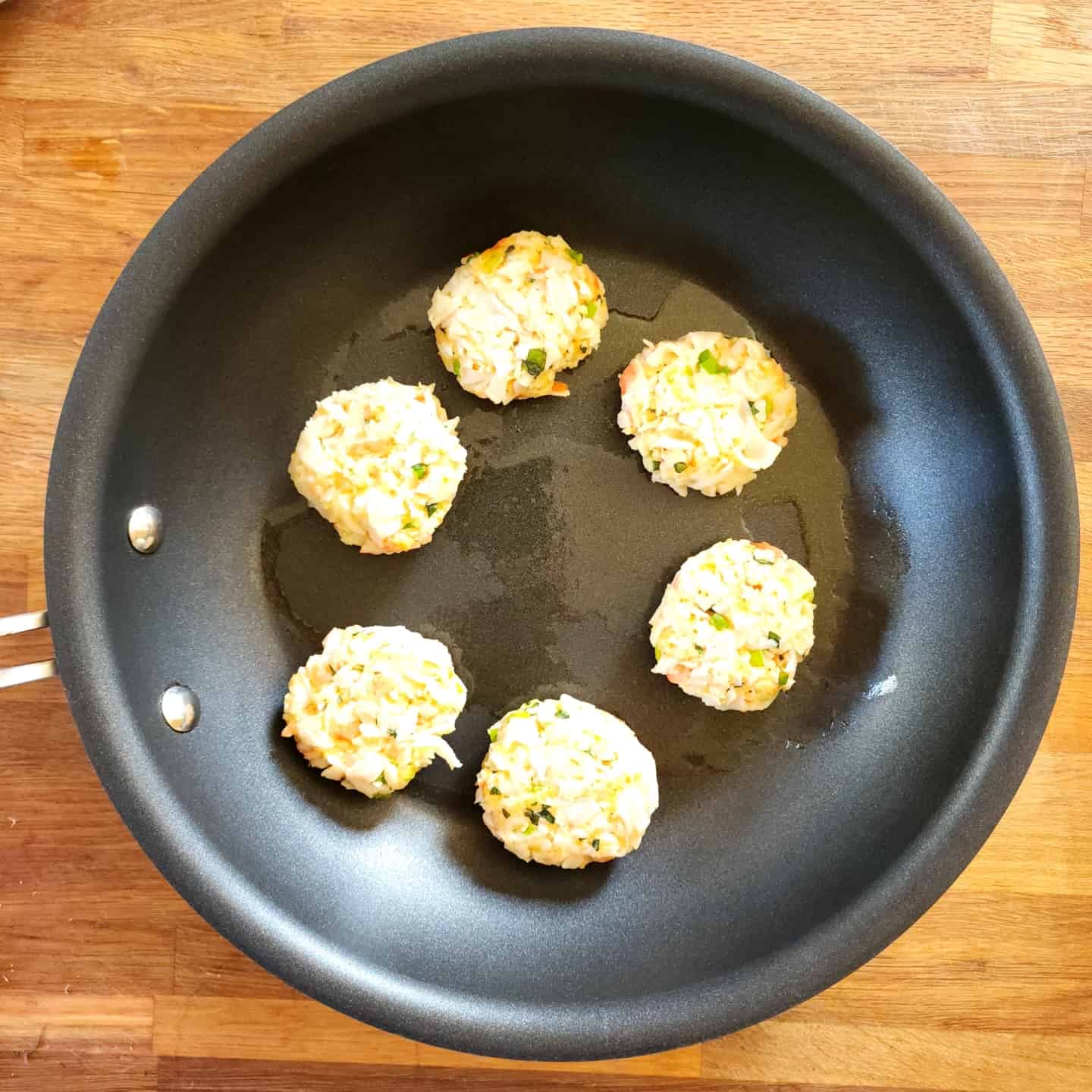 crab cakes in hot skillet