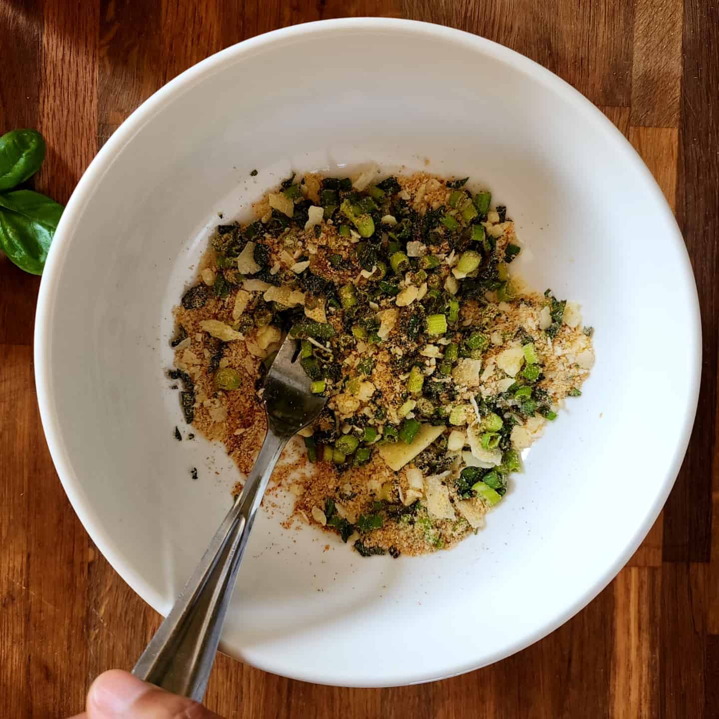 Combination of parmesan cheese, panko bread crumbs, mayo, Old Bay spice, minced green onions, and basil