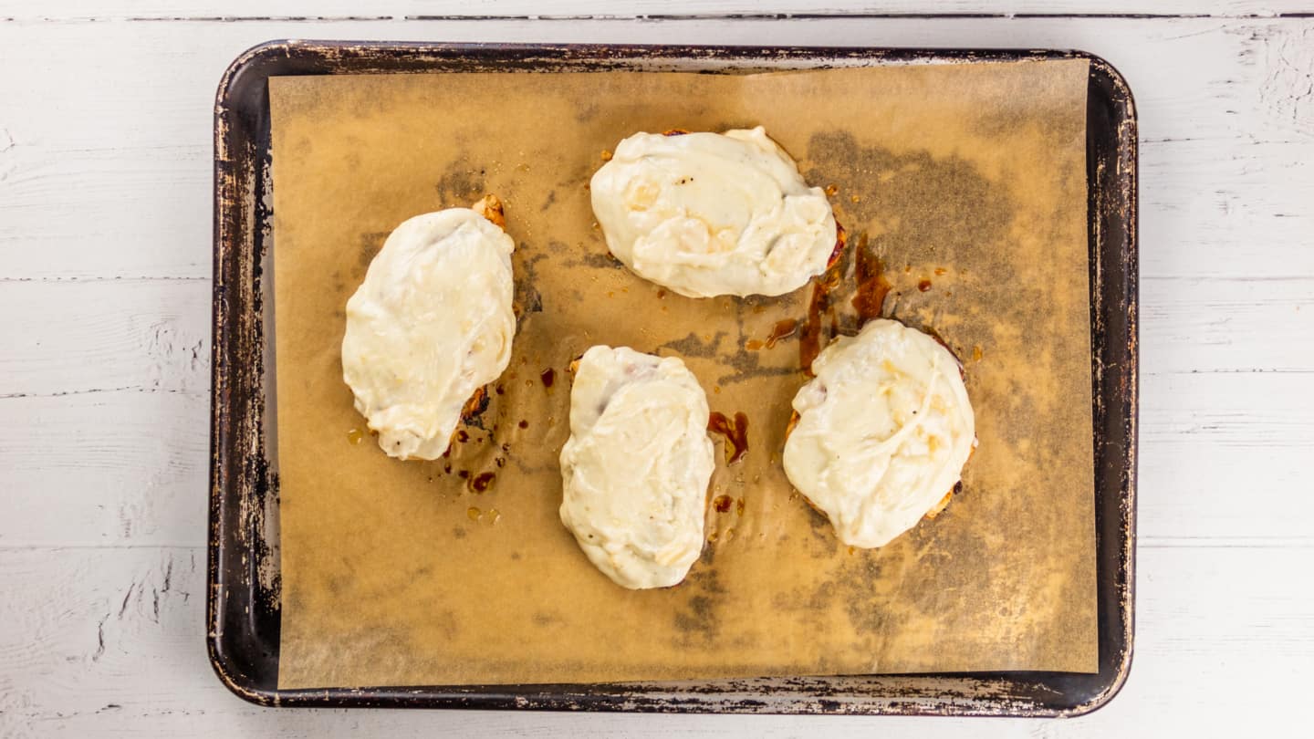 Spreading of ranch spread on top of chicken