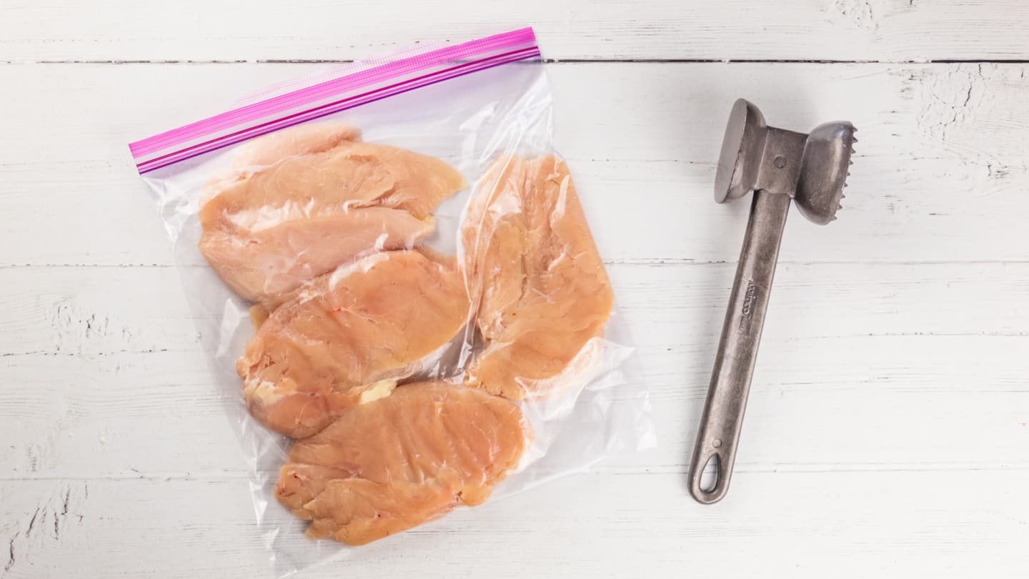 Placing the chicken breasts in freezer bag
