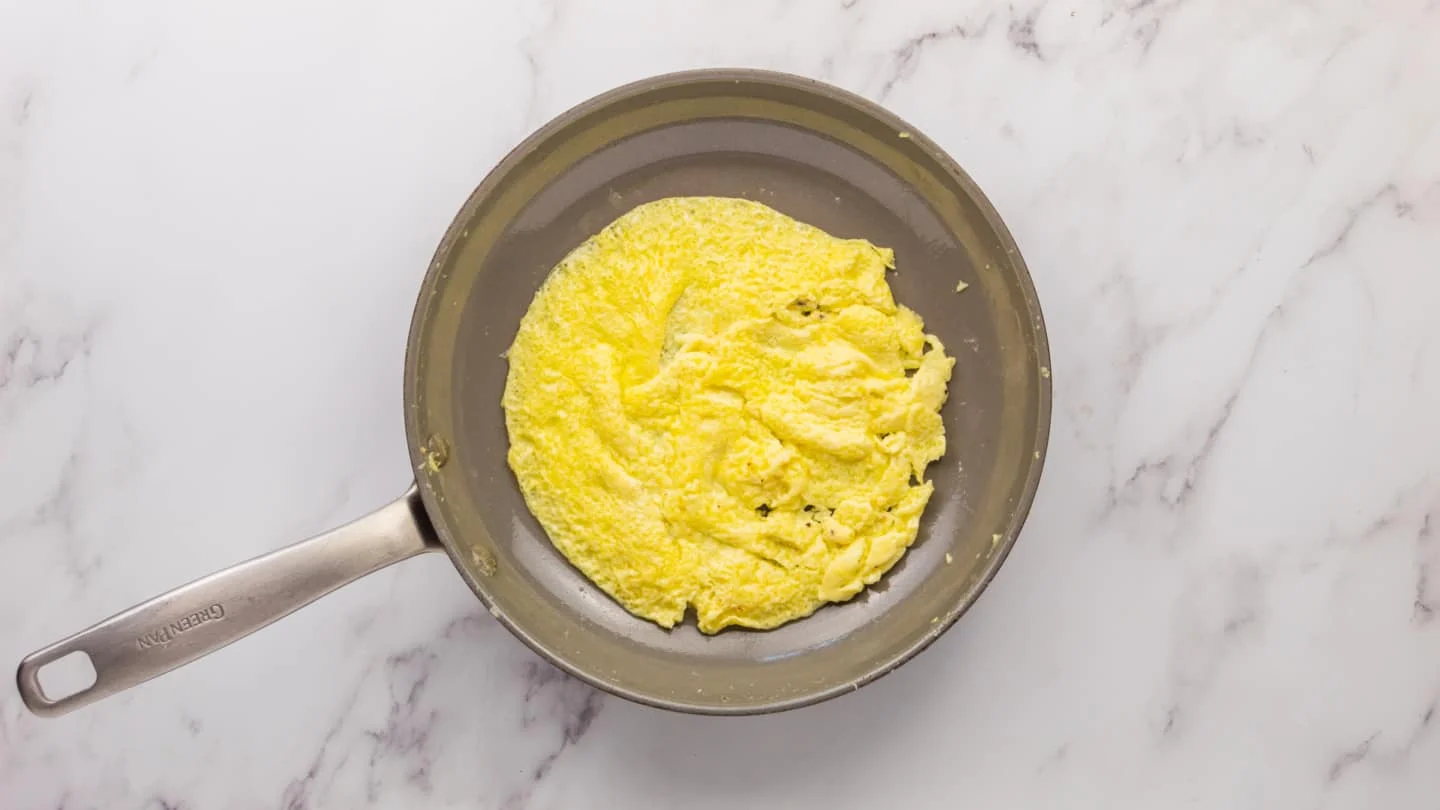 add ¼ of eggs in the pan