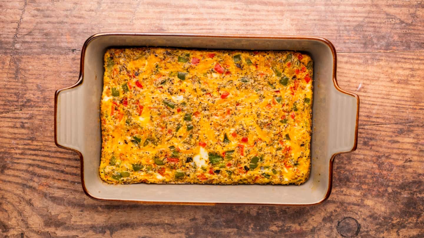 Remove the egg casserole from the oven and allow it to cool for 5 to 10 minutes before cutting it into squares and serving.
