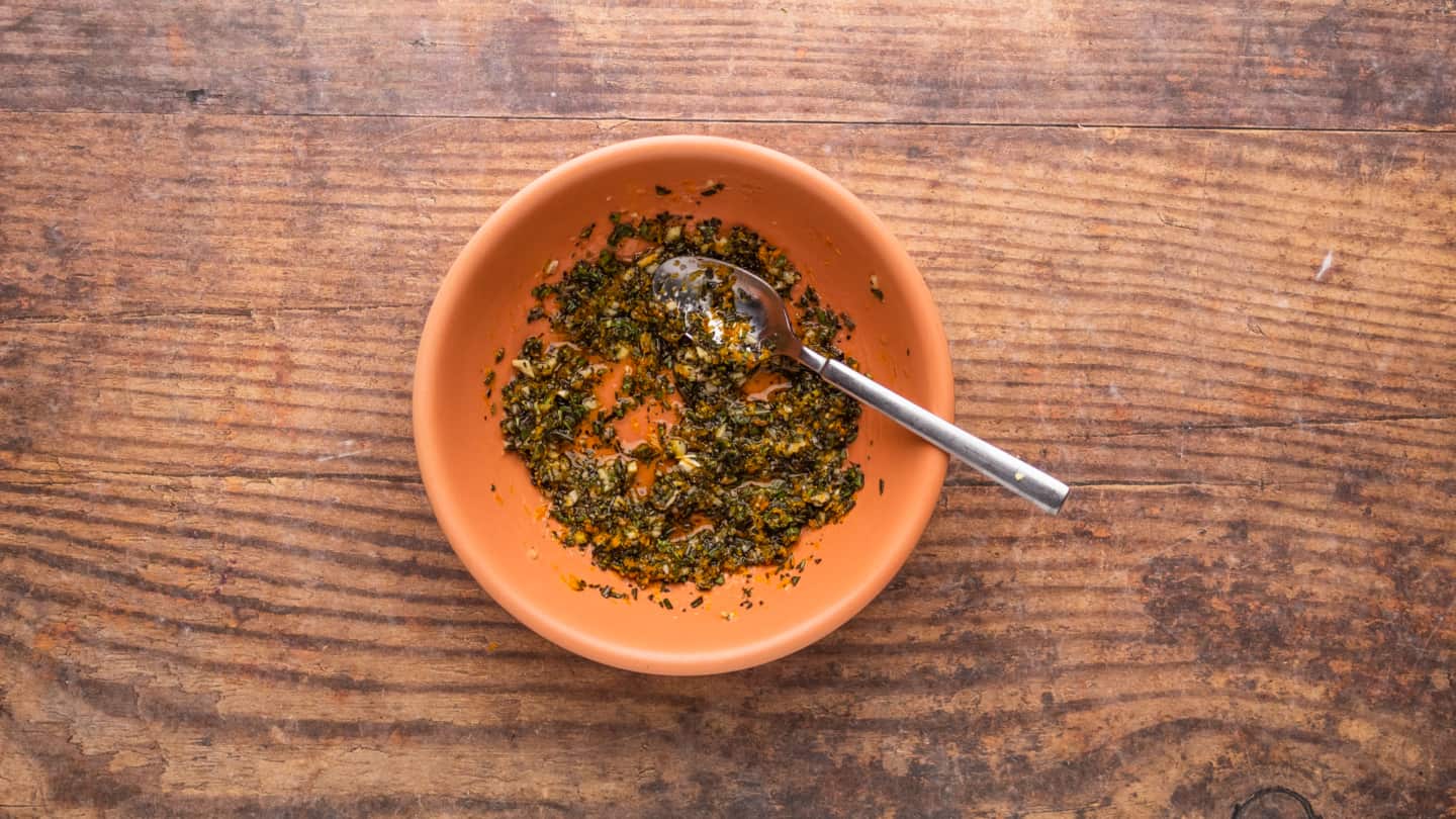 combine the olive oil, chopped garlic, kosher salt, freshly ground black pepper, sage, rosemary, thyme, and orange zest in a small bowl